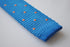 royal blue skinny knitted tie with orange polka dots